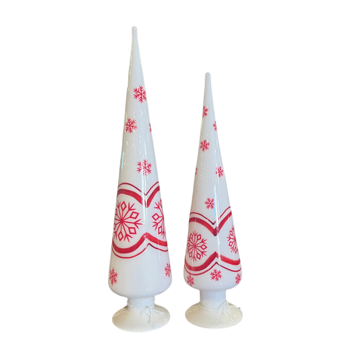 Two white glass Christmas trees with red snowflake patterns on a white background