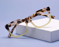 Tortoiseshell glasses on a white box with a light blue background