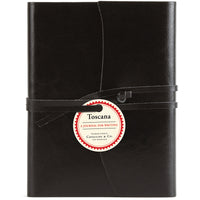 Black leather journal with a label on a white background
