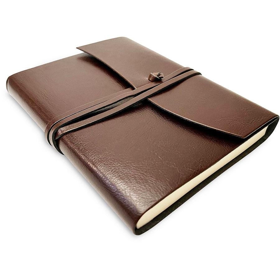 Brown leather notebook with a strap on a white background