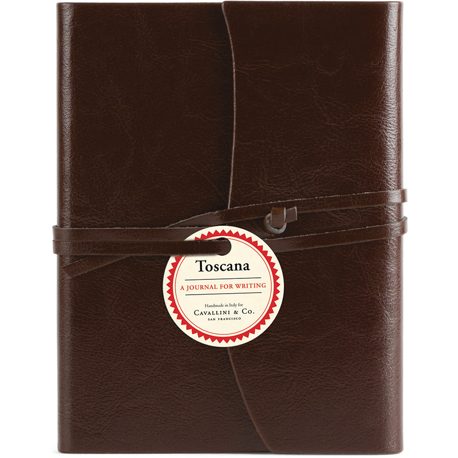 Brown leather journal with a label on a white background