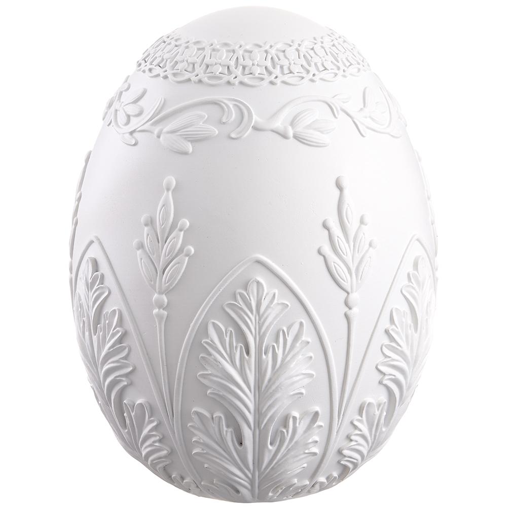 Decorative white egg with intricate patterns on a white background