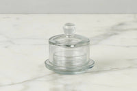 Clear glass jam jar with lid on a marble surface