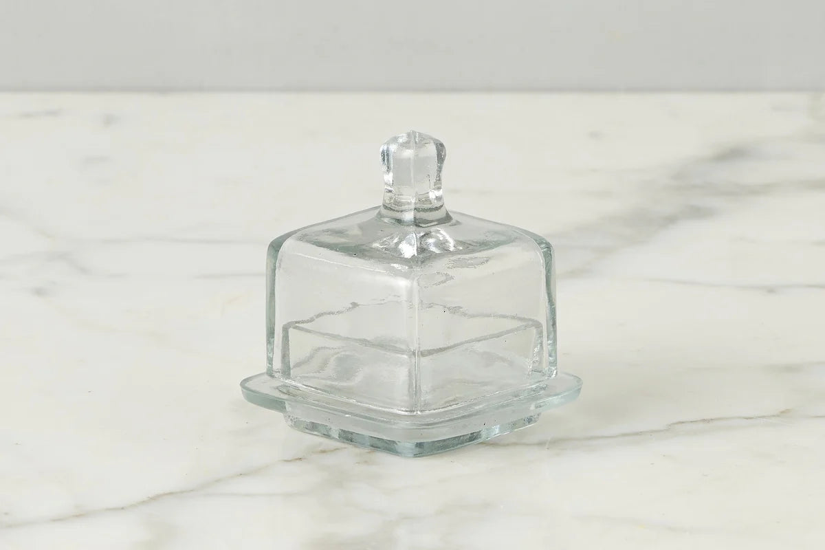 Clear square glass jam jar on a marble surface