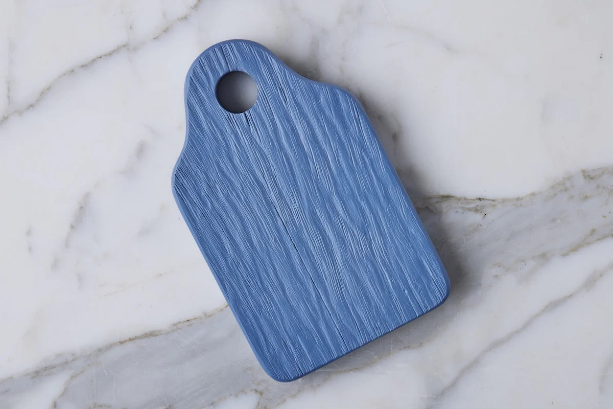 Blue serving board on a marble surface