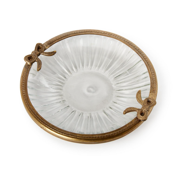 Decorative glass trinket tray with a gold rim on a white background