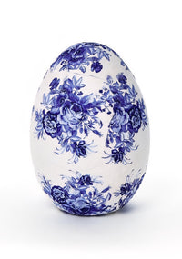 Decorative egg with blue floral pattern on a white background