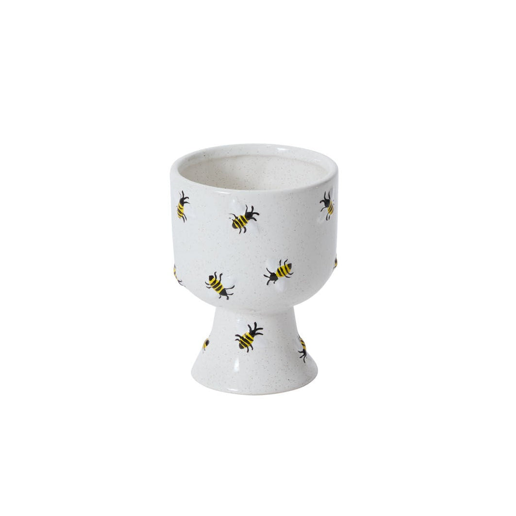 White ceramic compote with bee pattern on a white background