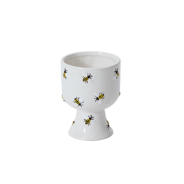 White ceramic compote with bee pattern on a white background