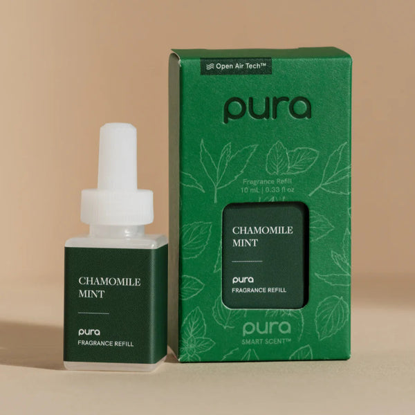 A Pura brand chamomile mint smart vial fragrance refill, with the product next to its green packaging box. The vial has a white dropper and the packaging is labeled 'Chamomile Mint' with green leaves and a mint graphic.