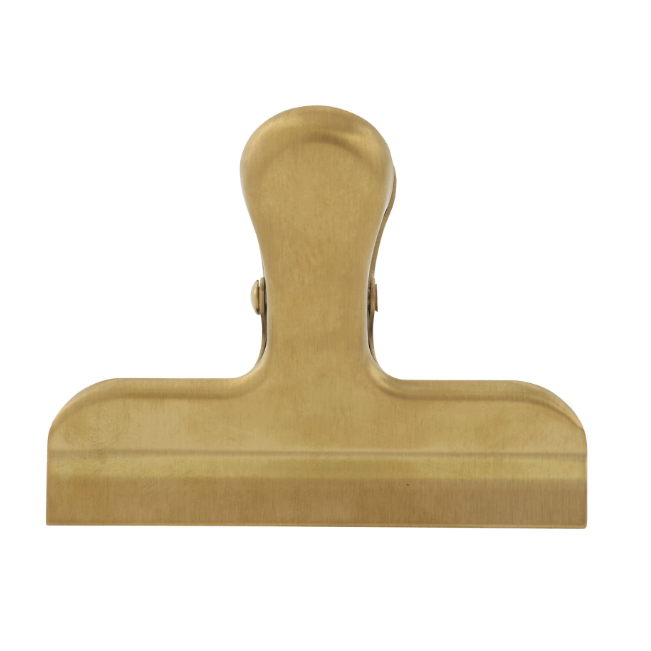 A gold-tone stainless steel clip with a shiny finish