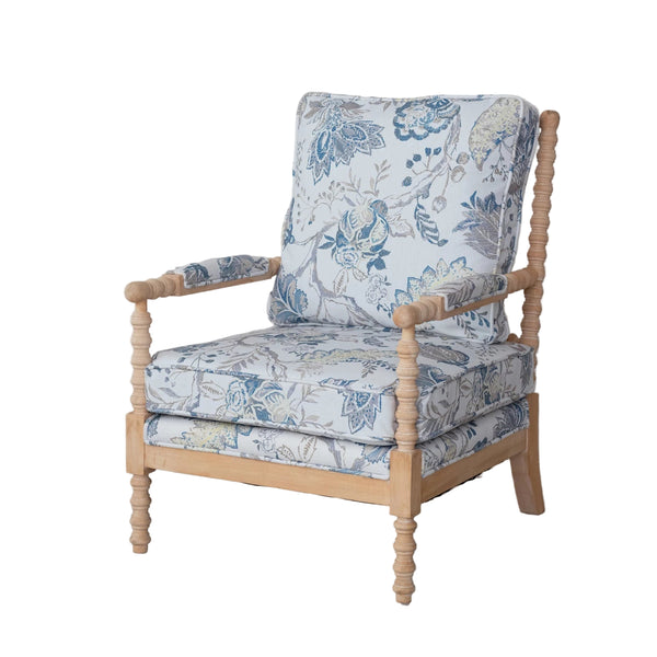 Chair with floral patterned cushions on a light wooden frame against a plain background