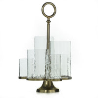 A brass and glass candle holder with five removable glass holders, featuring a circular brass top and base with a decorative element on top.