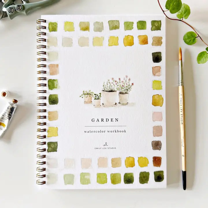 Watercolor workbook titled 'Garden' with color swatches on a white surface.