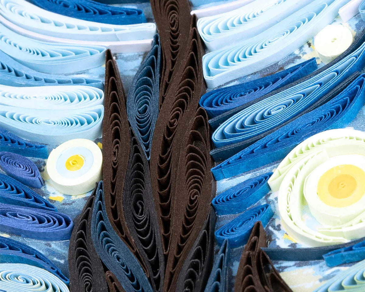 Close-up of a paper quilling 'Starry Night' art piece with blue, brown, and white colors.