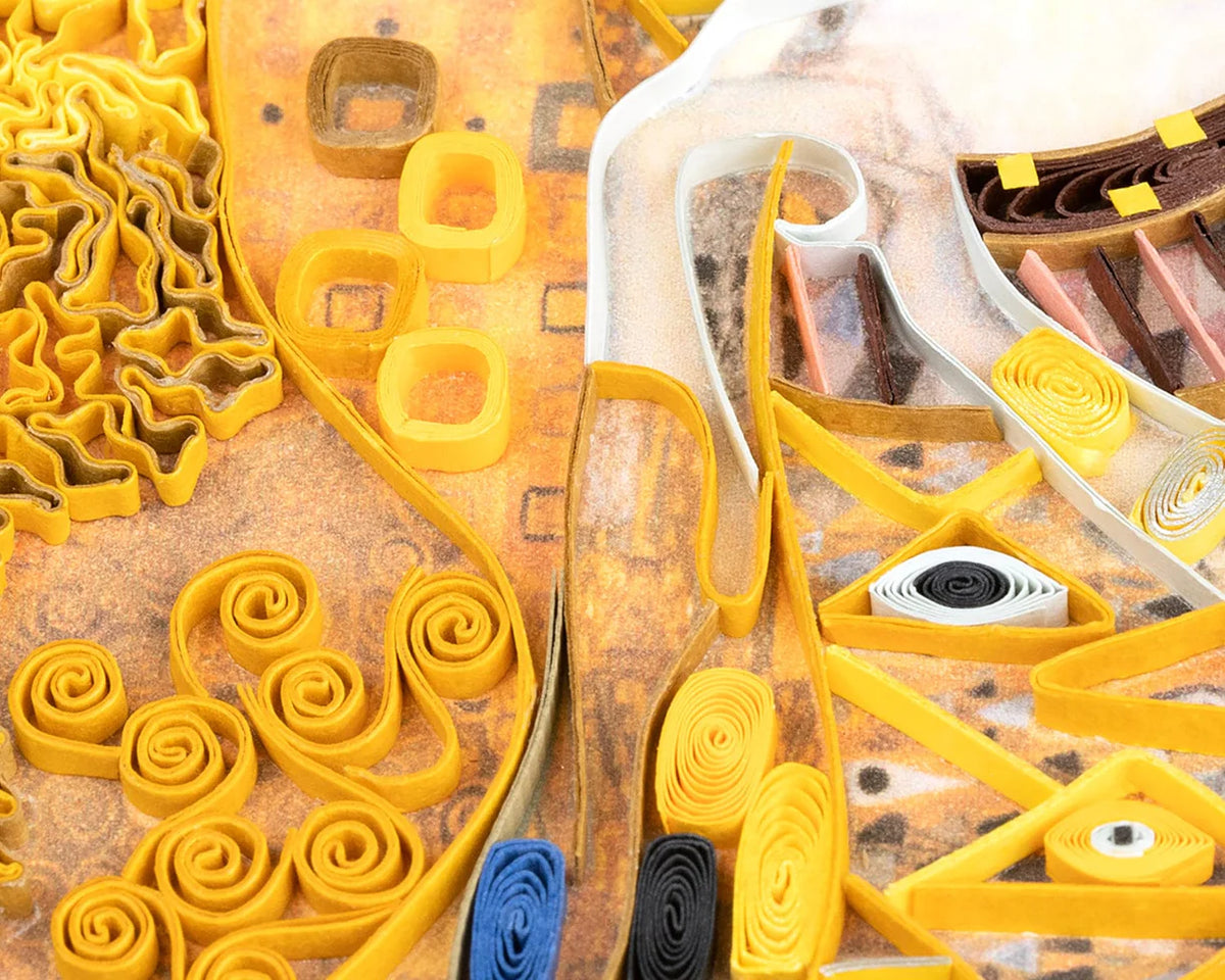 Closeup of a section of a quilled greeting card resembling Klimt's 'Lady in Gold'