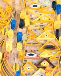 Closeup of a section of a quilled greeting card resembling Klimt's 'Lady in Gold'