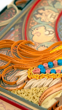 Closeup of quilled greeting card featuring Alphonse Mucha's 1896 lithograph 'Zodiac'