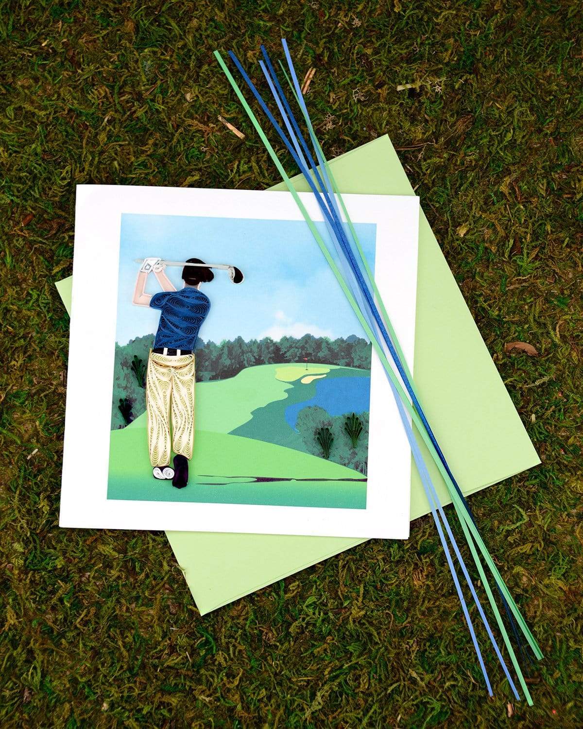 Greeting card with a quilled golf illustration on grass