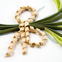 Quilled beige ribbon loops on a white background