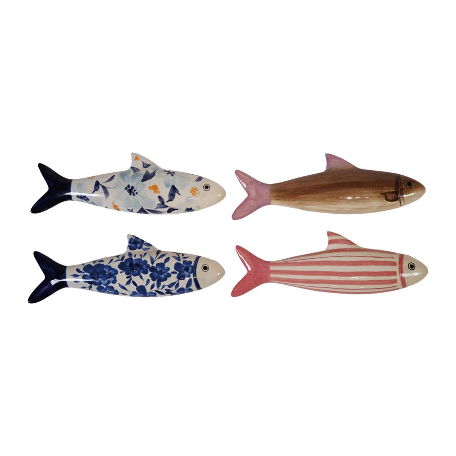 Four decorative fish figurines with floral and striped patterns on a white background