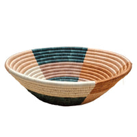 Woven basket with multicolor pattern on a white surface