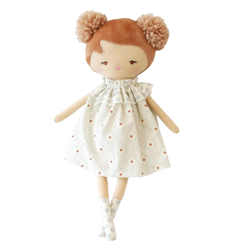 Plush doll with brown hair and a patterned dress on a white background