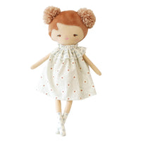 Plush doll with brown hair and a patterned dress on a white background