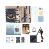 Collage of items including a book, small models, and electronic components on a white background
