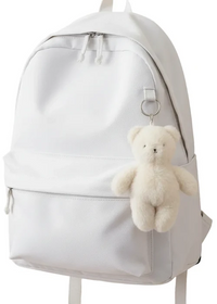 White backpack with a teddy bear keychain on a white background