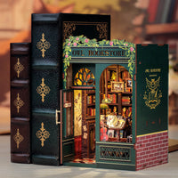 Model of an owl bookshop inside a large book with decorative cover