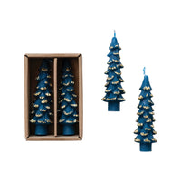 Set of blue candle trees with gold accents, one in a box and two on a white background.