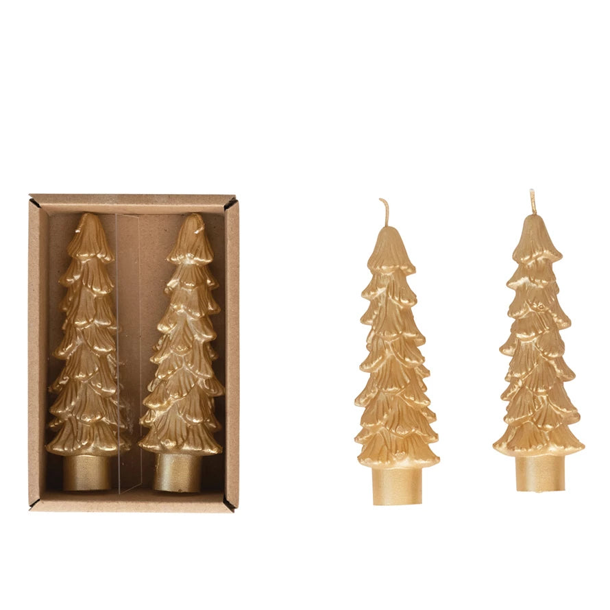 Gold tree-shaped candles with one in packaging on a white background