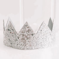 A silver sequin crown with pointed peaks, photographed against a clean white background.