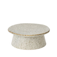 Round stone-like serving stand on a white background