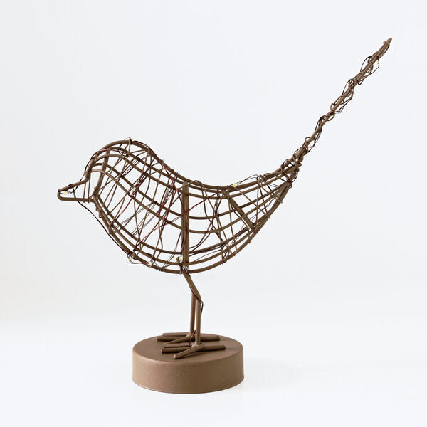 Copper wire bird sculpture on a white background