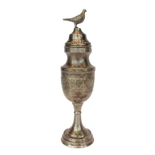 Antique-style silver pigeon racing trophy with a bird perched atop a cylindrical base.