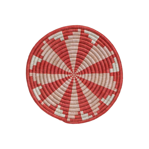 A round woven trivet with red and white stripes, featuring a central loop for hanging.